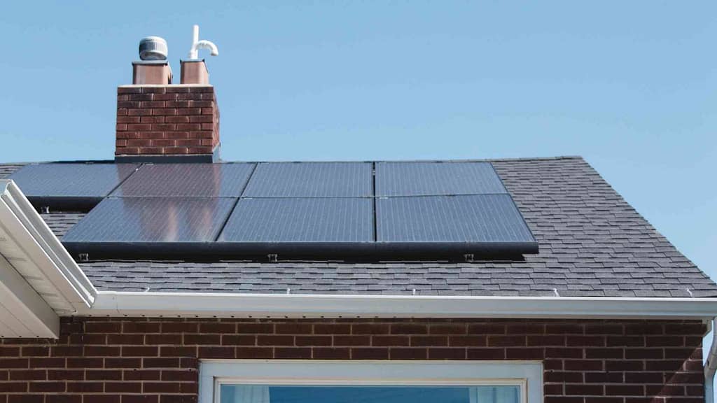 Stylish gray asphalt shingles and solar panels installed by American Home Contractors, the top choice for roofing and solar services in Morristown, NJ