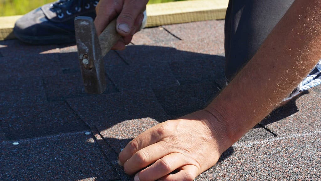 Person installing new shingle