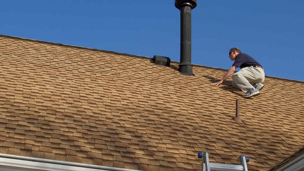 person inspecting the roof