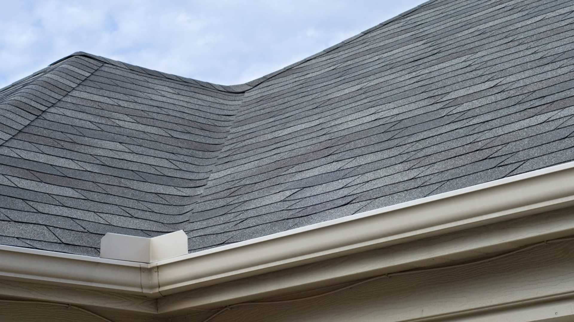 Asphalt shingle roof with new gutters installed