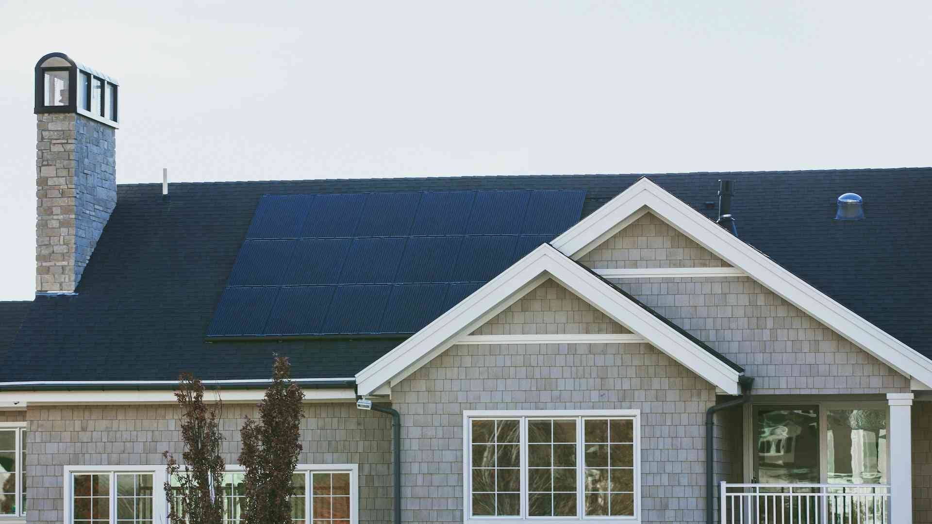 Residential home with solar panel installation by American Home Contractors in East Hanover, NJ