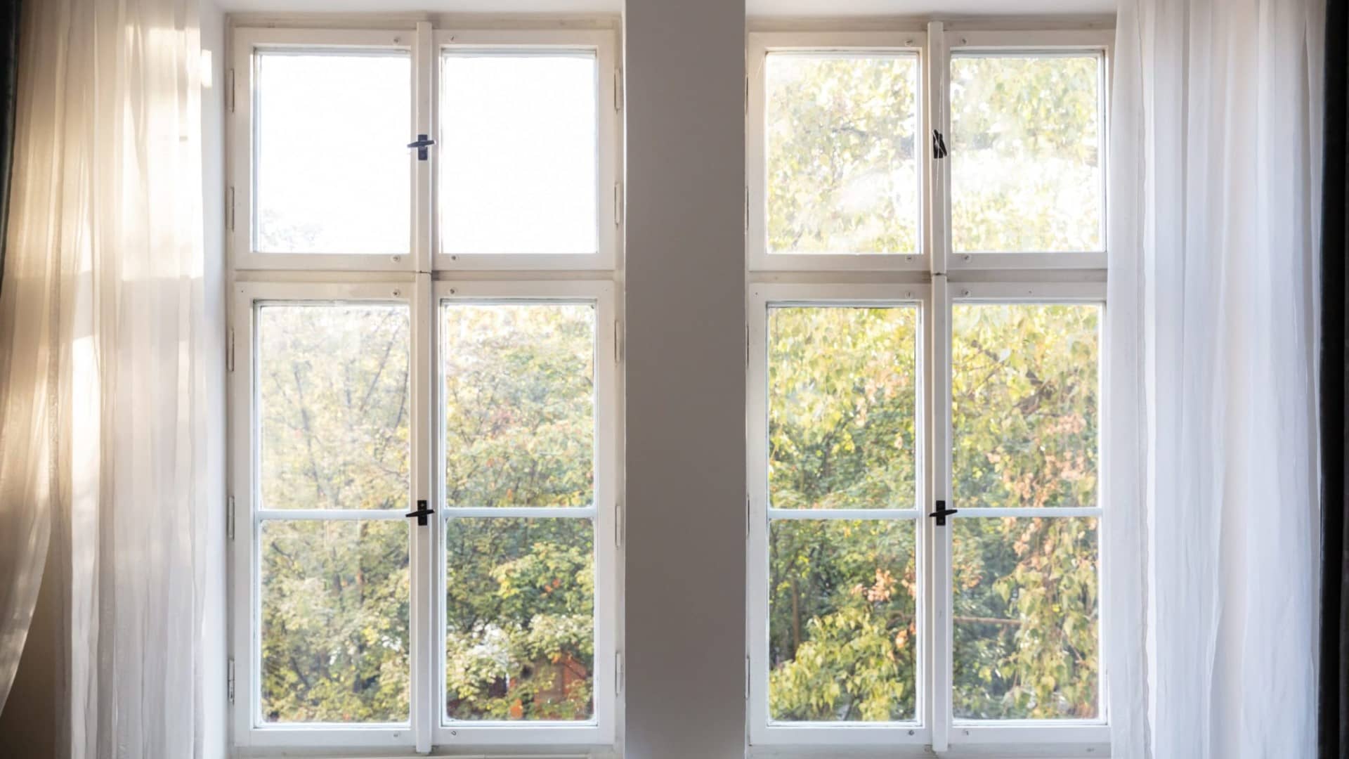 Fiberglass Windows with curtains by American Home Contractors